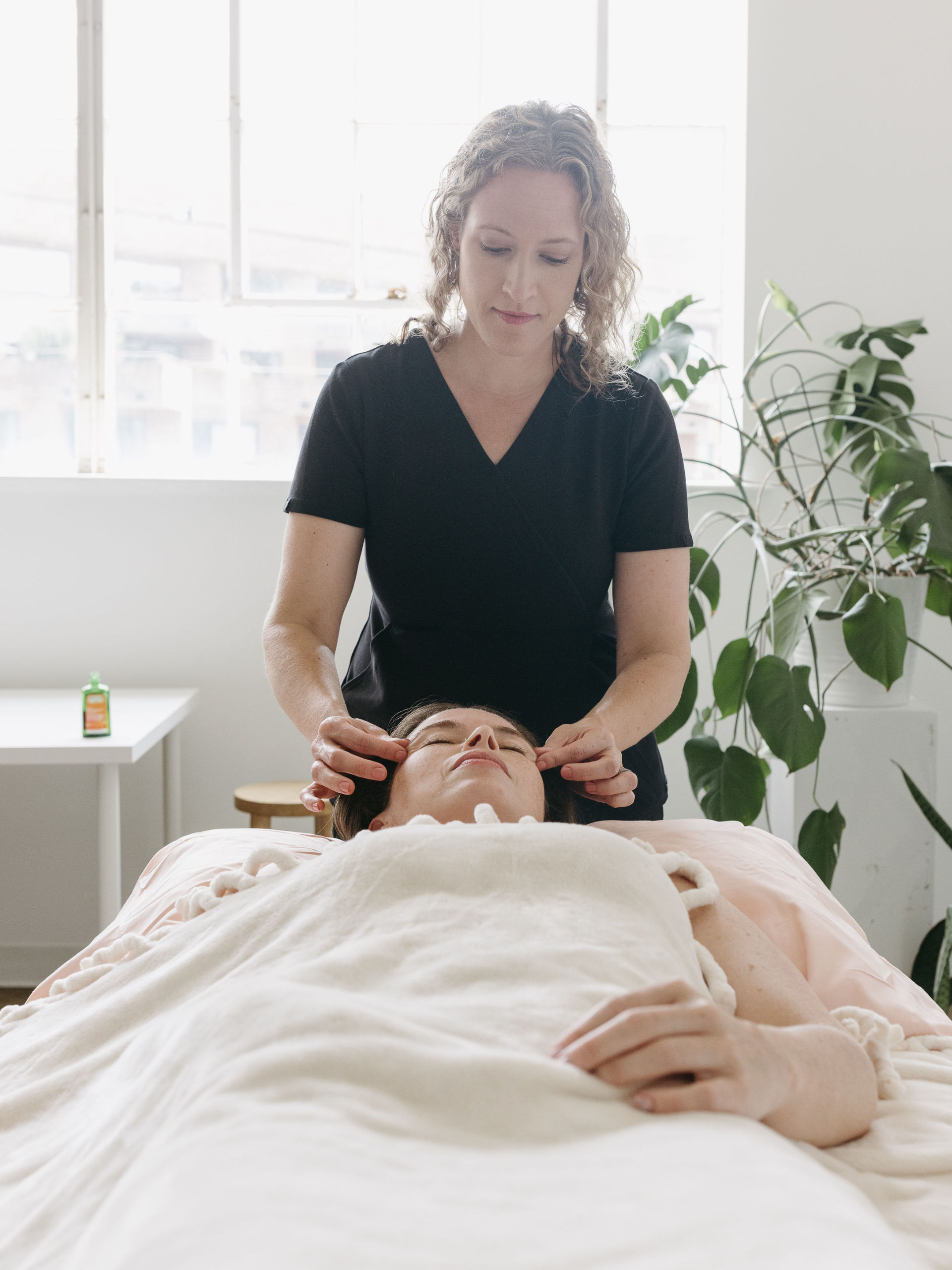 Women laying on her back getting an acupuncture treatment at Cherry Blossom Healing Arts